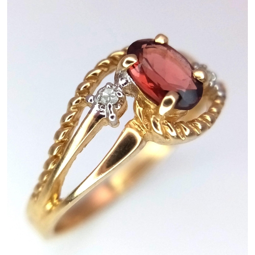 85 - A 10k Yellow Gold Garnet and Diamond Crossover Ring. Size L. 1.86g weight.