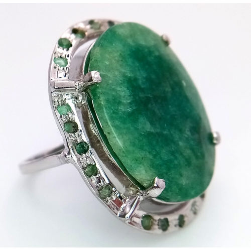 860 - An Emerald Oval Cut 925 Silver Ring with an Emerald Halo. 45ctw. W-15.20g. Size Q. Comes with a pres... 