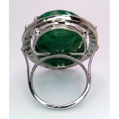 860 - An Emerald Oval Cut 925 Silver Ring with an Emerald Halo. 45ctw. W-15.20g. Size Q. Comes with a pres... 