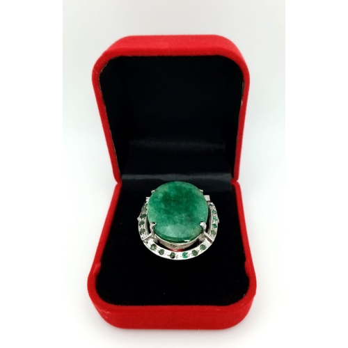 860 - An Emerald Oval Cut 925 Silver Ring with an Emerald Halo. 45ctw. W-15.20g. Size Q. Comes with a pres... 