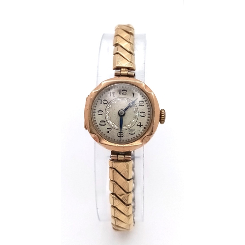 96 - A Vintage 9K Gold Cased Ladies Watch. Expandable gilded strap. 9K gold case - 21mm. White dial. Mech... 