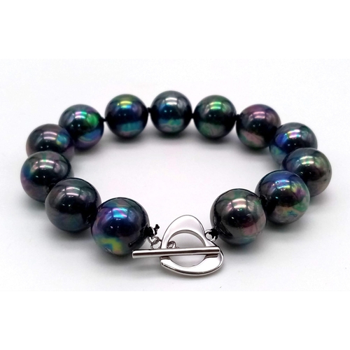 1281 - A Metallic Dark Grey South Sea Pearl Shell Bead Bracelet. Heart clasp. 14mm beads.