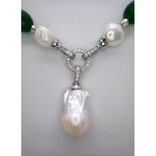 1324 - A Green Jade Necklace with a Baroque Pearl Pendant. 10mm green jade beads lead to a baroque pearl pe... 