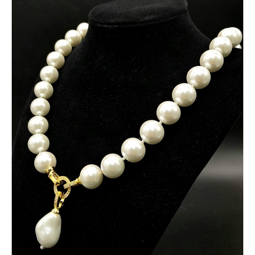 402 - A South Sea Pearl Shell White Bead Necklace with a Baroque Pearl Pendant. Large glossy 14mm beads. G... 