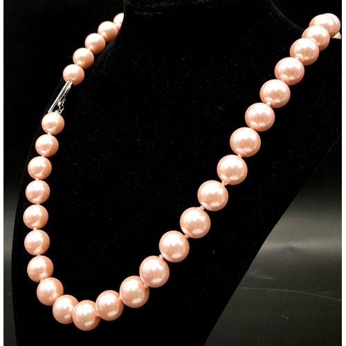 883 - A Bright Pink South Sea Pearl Shell Bead Necklace with Heart Clasp. 12mm beads. 55cm necklace length... 