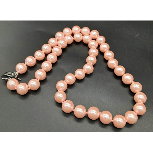 883 - A Bright Pink South Sea Pearl Shell Bead Necklace with Heart Clasp. 12mm beads. 55cm necklace length... 