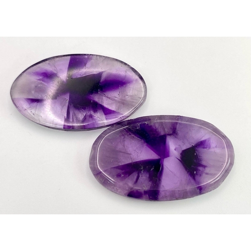 222 - A rarely seen and very desirable pair of large AMETHYST cabochons, exhibiting radiating banded colou... 