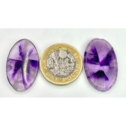 222 - A rarely seen and very desirable pair of large AMETHYST cabochons, exhibiting radiating banded colou... 