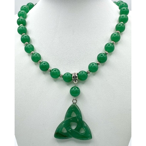 250 - A quality green jade necklace with pendant and earrings in an “eternal triangle” design symbolising ... 