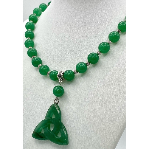 250 - A quality green jade necklace with pendant and earrings in an “eternal triangle” design symbolising ... 