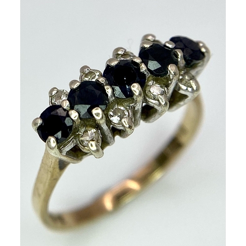 26 - A Classic Vintage Sapphire and Diamond Ring. Five sapphires between four two rows of diamonds. Size ... 