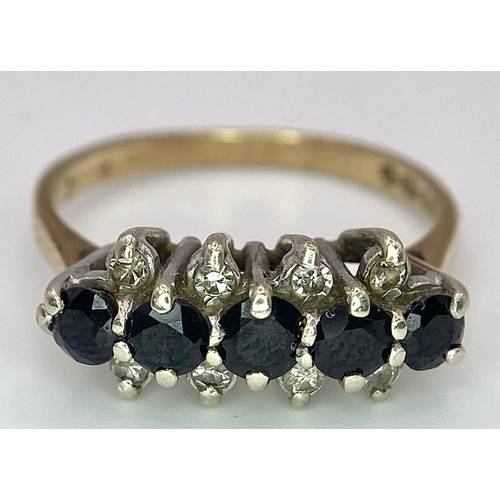 26 - A Classic Vintage Sapphire and Diamond Ring. Five sapphires between four two rows of diamonds. Size ... 