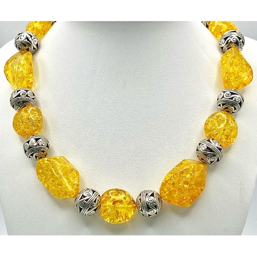 271 - A substantial necklace, bracelet and earrings set with Tibetan silver alternating with amber resin, ... 