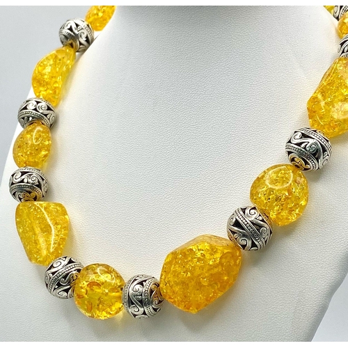 271 - A substantial necklace, bracelet and earrings set with Tibetan silver alternating with amber resin, ... 