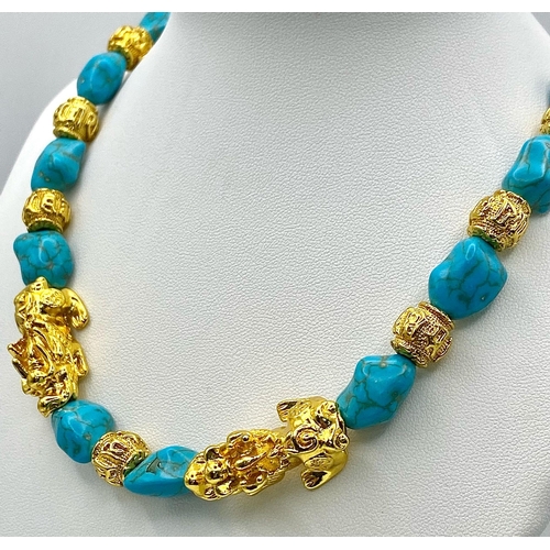 292 - A glamorous necklace and matching earrings set with turquoise nuggets, gold filled “Good Luck” beads... 