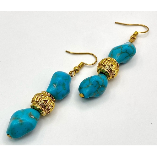 292 - A glamorous necklace and matching earrings set with turquoise nuggets, gold filled “Good Luck” beads... 