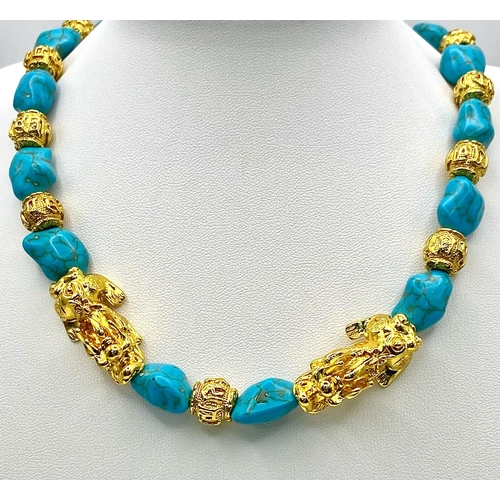 292 - A glamorous necklace and matching earrings set with turquoise nuggets, gold filled “Good Luck” beads... 