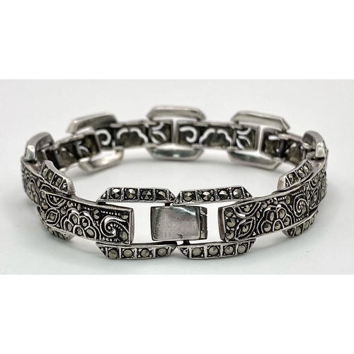 313 - A vintage, sterling silver bracelet, with an elaborate filigree design studded with marcasite. Hallm... 