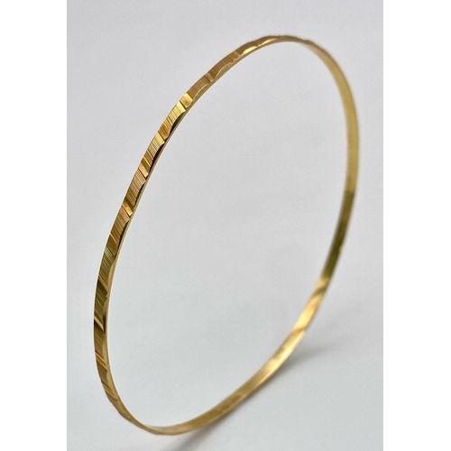 8 - A 9K yellow Gold Thin Bangle. 3mm width. 6cm inner diameter. 3.67g weight.