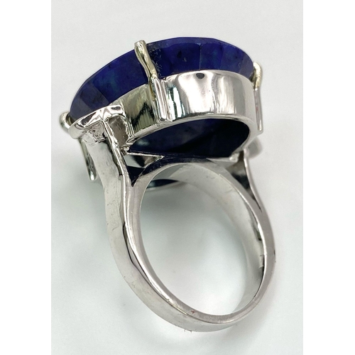 853 - A Large Oval Cut Blue Sapphire 925 Silver Ring. 35ct. W-14.3g. Size O. Comes with a presentation cas... 