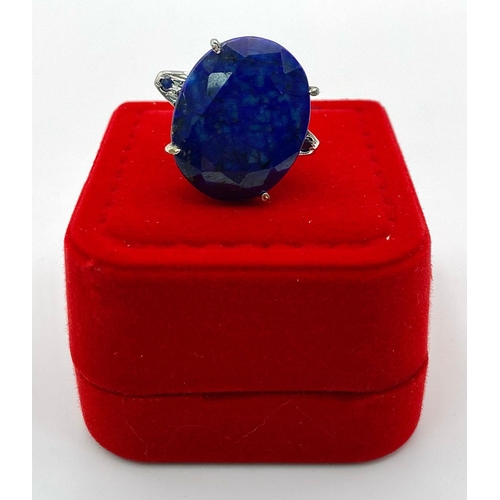 853 - A Large Oval Cut Blue Sapphire 925 Silver Ring. 35ct. W-14.3g. Size O. Comes with a presentation cas... 