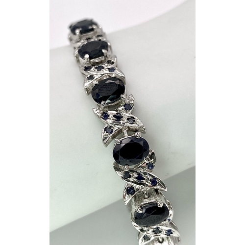 867 - An Oval Cut Blue Sapphire Tennis Bracelet set in 925 Sterling Silver. 33ctw. W-25g. 18cm length.