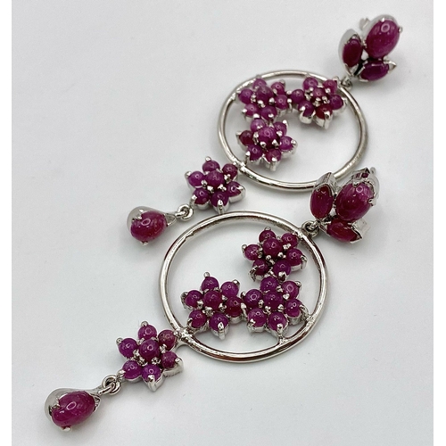 881 - A Pair of Ruby Decorative Floral Drop Earrings set in 925 Sterling silver. 24ctw. W-21.5g. 7cm drop.... 