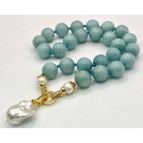 194 - A Fabulous Blue Aquamarine and Baroque Pearl Necklace. 14mm aquamarine beads give way to an irregula... 