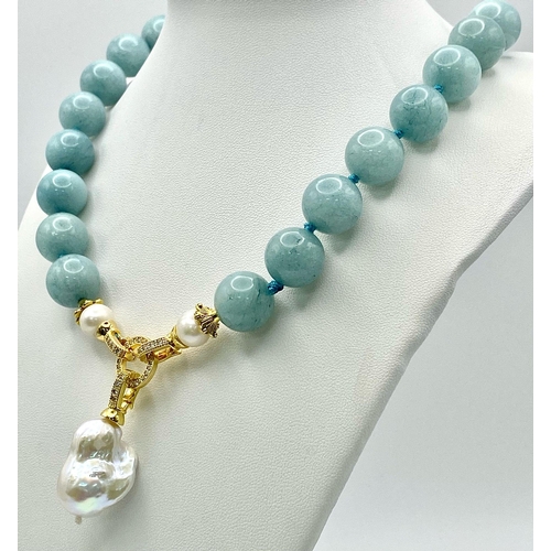 194 - A Fabulous Blue Aquamarine and Baroque Pearl Necklace. 14mm aquamarine beads give way to an irregula... 