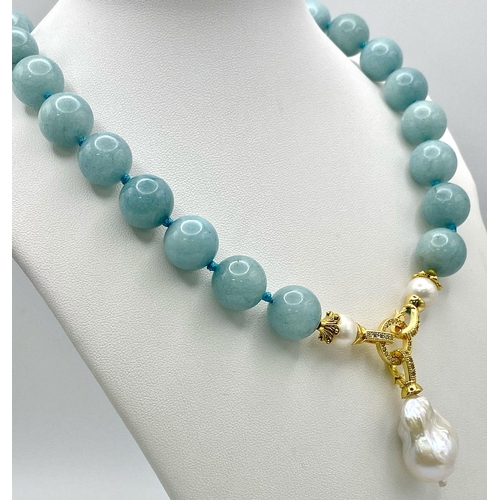 194 - A Fabulous Blue Aquamarine and Baroque Pearl Necklace. 14mm aquamarine beads give way to an irregula... 