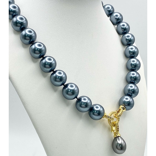 242 - A Metallic Grey South Sea Pearl Shell Necklace with a Teardrop Pendant. 14mm large beads. Gilded and... 