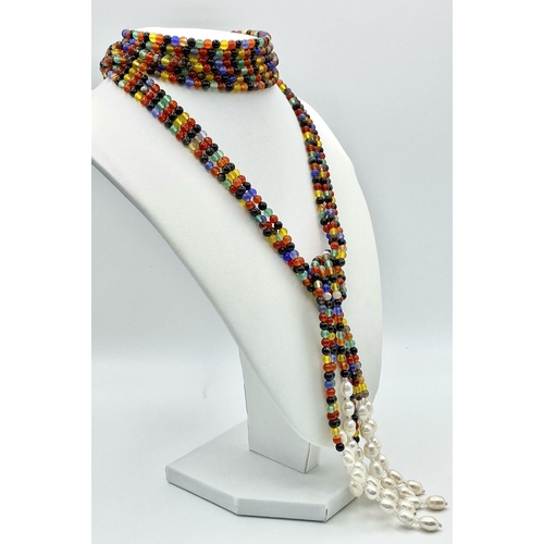 257 - A very interesting necklace consisting of three very long (125 cm) strands of multicoloured beads an... 