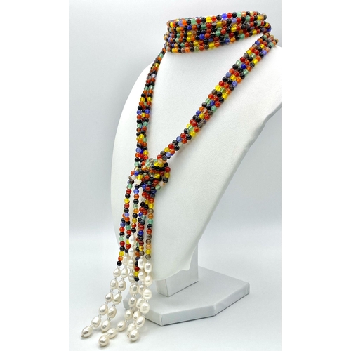 257 - A very interesting necklace consisting of three very long (125 cm) strands of multicoloured beads an... 