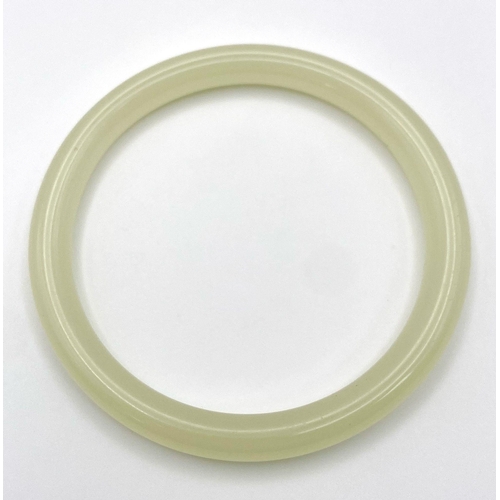 498 - A Pale Green Thin Jade Bangle. 8mm width. 6cm inner diameter.