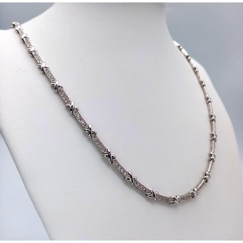 1251 - An 18K White Gold and Diamond Bar Link Necklace. 1.24ctw of diamonds. Love-knot separators. 43cm len... 