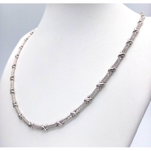 1251 - An 18K White Gold and Diamond Bar Link Necklace. 1.24ctw of diamonds. Love-knot separators. 43cm len... 