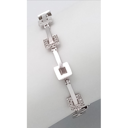 1228 - A 9K WHITE GOLD DIAMOND SET BRACELET. 9.9G