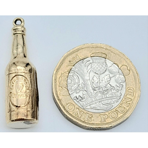 1527 - A 9K YELLOW GOLD GUINNESS BOTTLE CHARM. 1.5G