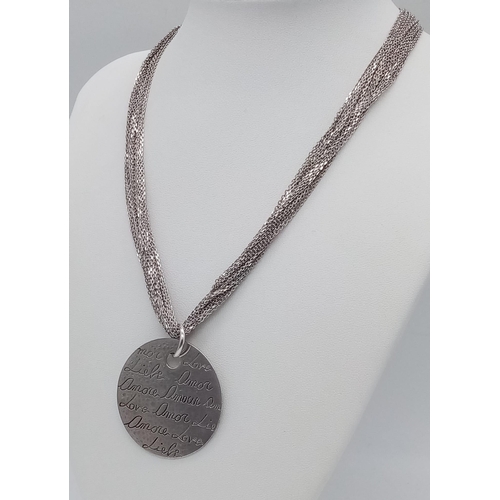 1541 - A sterling silver multi-strand chain necklace with a round pendant with the word LOVE in many langua... 