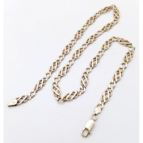 1195 - A 9k yellow gold fancy link chain. 17