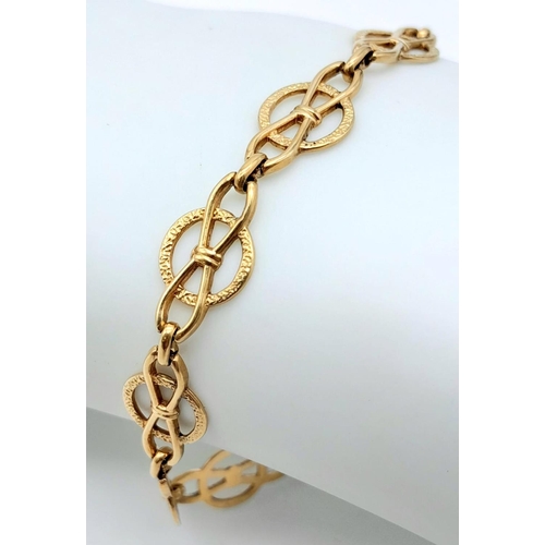 1555 - A 9k yellow gold openwork detailed bracelet with safety chain. 19cm length. 6.6g.