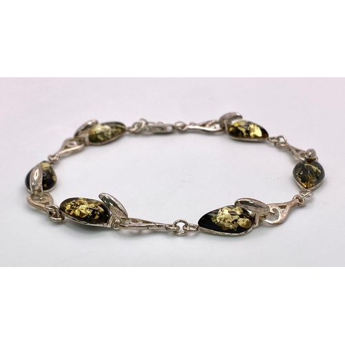 1680 - A Sterling silver selection of 3 amber pieces, including 2 rings and a bracelet, 17.6g collective we... 