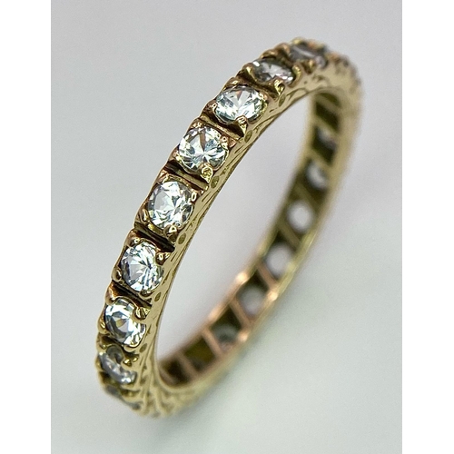 1687 - A 9k yellow gold full eternity band ring set with cubic zirconia 2.5g, size R.