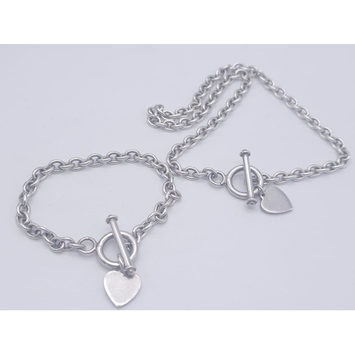 1701 - A Sterling silver T-bar heart necklace with matching 20cm bracelet. 54.3g total weight.