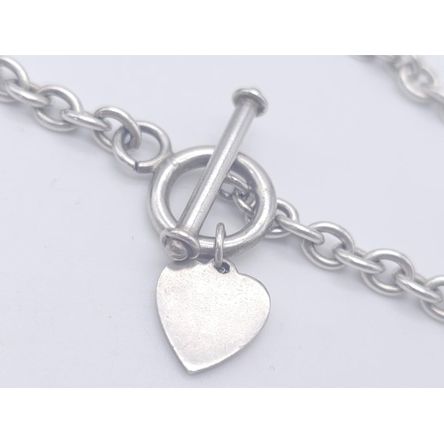 1701 - A Sterling silver T-bar heart necklace with matching 20cm bracelet. 54.3g total weight.