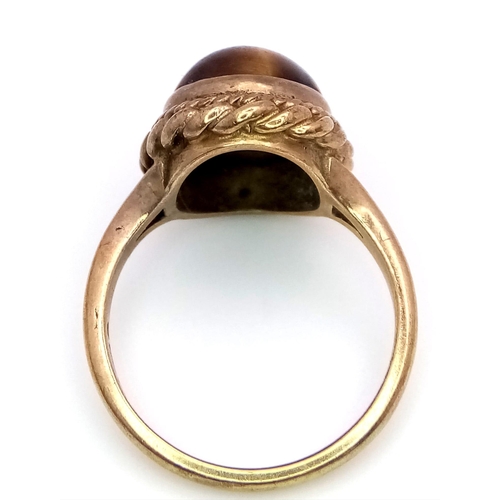 1728 - A Vintage 9K Yellow Gold Tigers Eye Cabochon Ring. Size N. 5g total weight.