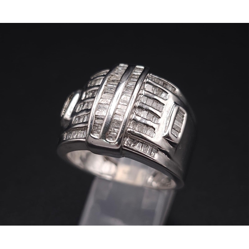 1511 - A 10K White Gold Baguette Diamond Cluster Ring. Size V. 1ctw. 7.4g total weight.