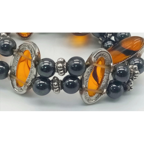 1164 - A stunning Haematite and Amber adjustable charm bracelet. Please see photos for details.