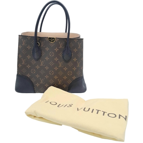 127 - A Louis Vuitton Monogram Flandrin Handbag. Leather exterior with gold-toned hardware, two rolled lea... 