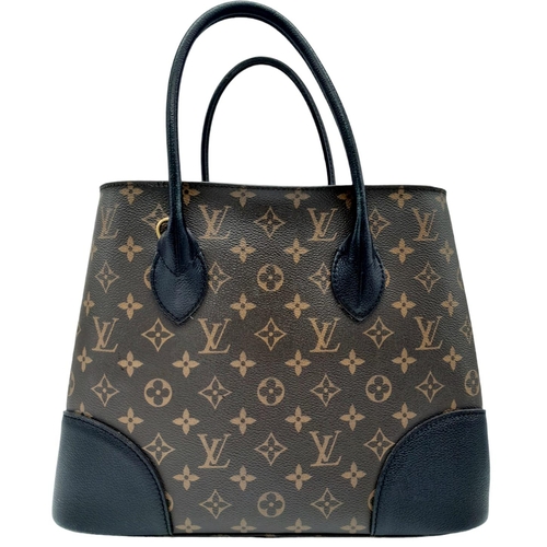 127 - A Louis Vuitton Monogram Flandrin Handbag. Leather exterior with gold-toned hardware, two rolled lea... 